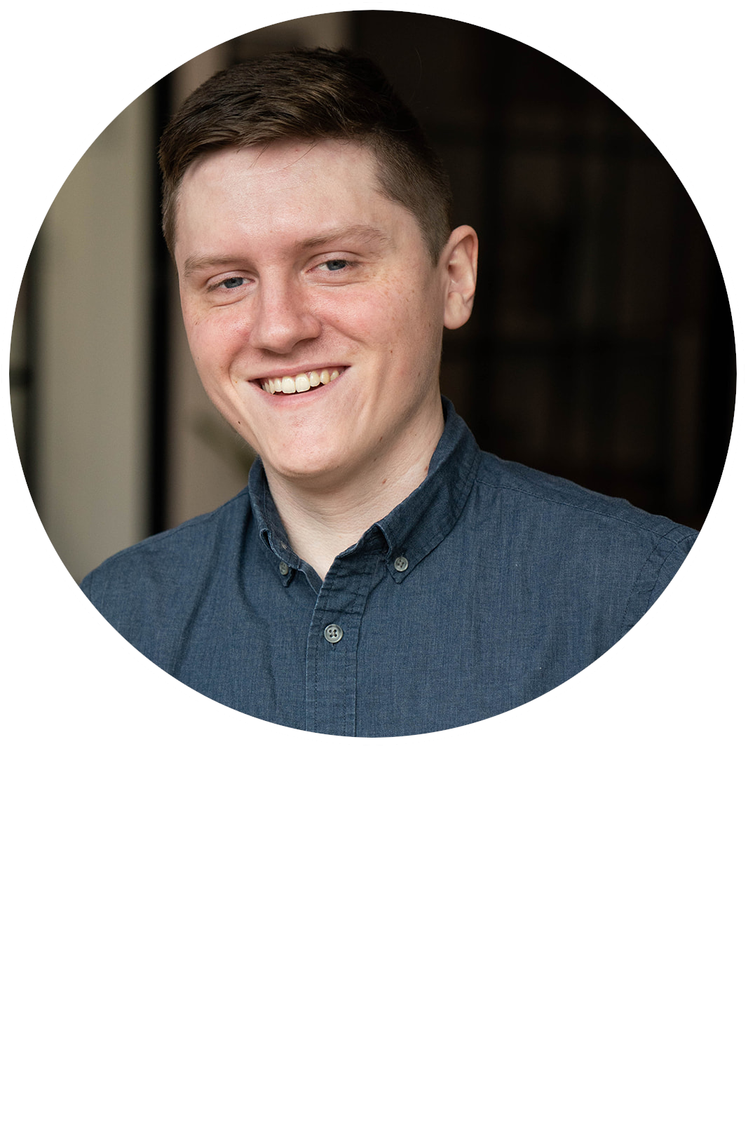 A headshot of Zane Bartlett in a button up
